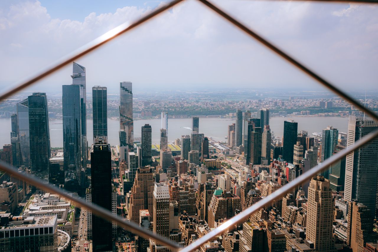 A stunning aerial view of Manhattan's skyline featuring prominent skyscrapers and urban landscape.